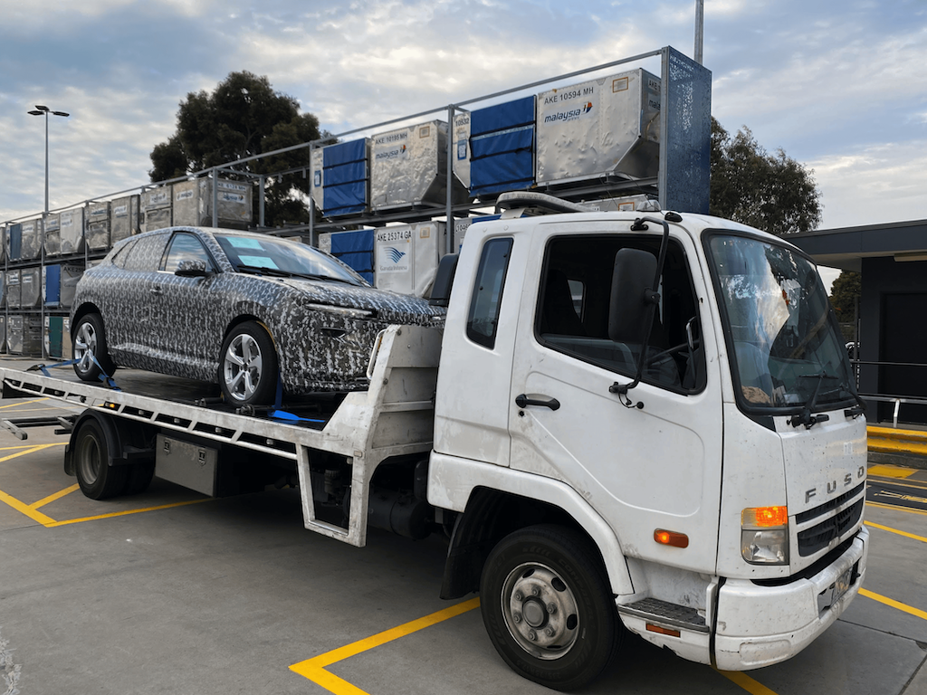 A long-distance tow for a brand new wrapped car.